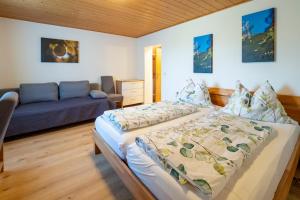 sypialnia z dwoma łóżkami i kanapą w obiekcie Gästezimmer Ilse Brauneis w mieście Mautern