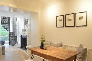 a dining room with a wooden table and a fireplace at MEERBLICK-MAISONETTE Ostseebad Kühlungsborn in Kühlungsborn +22 photos