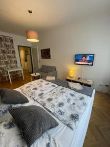 a bedroom with a bed and a tv on the wall at Agnes - Romance in city II. in Prague