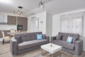 a living room with a couch and a table at Apartments & Rooms Seaside in Kaštela