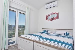 Postel nebo postele na pokoji v ubytování Apartments & Rooms Seaside