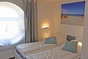 Cama ou camas em um quarto em Strandhus Windjammer