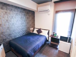 Postel nebo postele na pokoji v ubytování HOTEL LiVEMAX Kobe Sannomiya