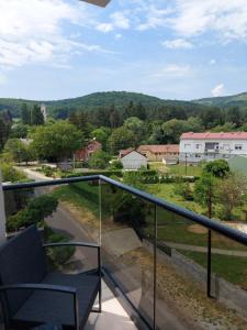 a balcony with a chair and a view of a yard at Vila Slap in Vrdnik