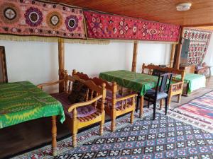 a dining room with a table and chairs and a table and a table and chairs at Hotel Nazira & Azizbek in Bukhara