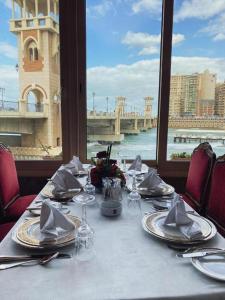 a dining table with a view of a bridge at San Giovanni Stanly Hotel in Alexandria