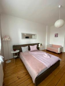 a bedroom with a large bed with a pink blanket at Ubytování Stará in Ústí nad Labem