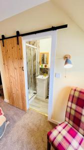 a room with a door leading to a bathroom at Aultguish Inn in Garve