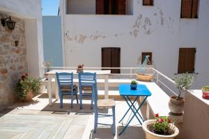 a patio with a table and chairs on a balcony at Aeolos Guesthouse in Monemvasia