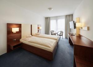 Letto o letti in una camera di Stadthotel am Wasen