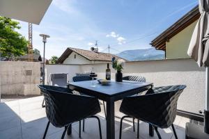 a black table and chairs on a patio with a view at Videre Lodge Gantkofel in Gargazzone