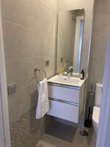 a bathroom with a sink and a mirror at Castelar Rooms in Las Palmas de Gran Canaria