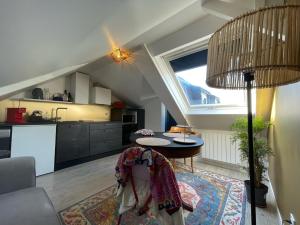 a living room with a table and a kitchen at 3DALIPHARD in Rouen