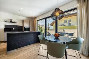 a dining room and kitchen with a table and chairs at Videre Lodge Wasserfall in Gargazzone +27 photos