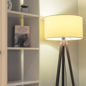 a lamp in a room next to a book shelf at Garden Boutique B&B in Tirana +29 photos