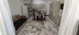 Квартира в Радуга WEST في Koshkolʼ: غرفة معيشة مع طاولة وأريكة