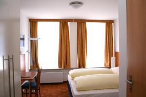 a hotel room with a bed and a window at Hotel Evido Salzburg City Center in Salzburg