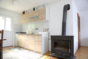a kitchen with a fireplace and a stove at Apartment Stanic in Šipovo
