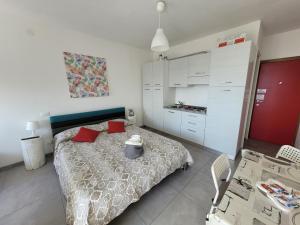 a bedroom with a bed and a table and some boxes at Rosato Sea View Apartment in Lignano Sabbiadoro