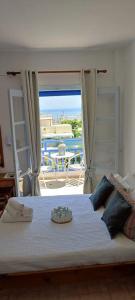 a bedroom with a bed with a view of a patio at Villa Dioni in Kamari