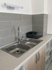 a stainless steel sink in a small kitchen at Apartments Villa Relax in Petrovac na Moru +55 photos