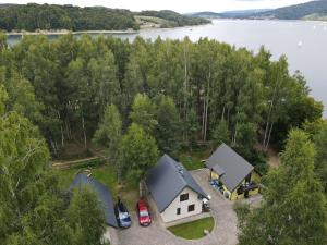 an aerial view of a house on the shore of a lake at Cypla Czar in Polańczyk
