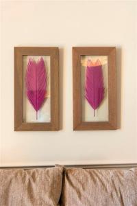 two pictures of purple leaves on a wall at Hôtel Le Royal Promenade des Anglais in Nice