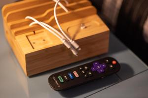 a remote control sitting next to a wooden box at Snowshoe Ski-in & Ski-out at Silvercreek Resort - Family friendly, jacuzzi, hot tub, mountain views in Snowshoe +20 photos