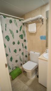a bathroom with a toilet and a shower curtain at Apartamento Los Patos Beach in Benalmádena
