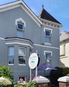 a house with a sign in front of it at Merritt Guest House B&B in Paignton