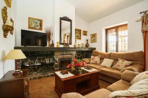 a living room with a couch and a fireplace at Villa Maravillas in Nerja