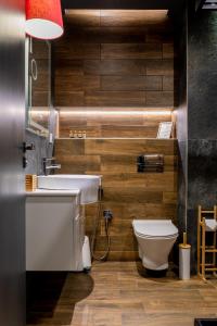 a bathroom with a white sink and a toilet at City Art Luxury Living Free Parking in Ruse