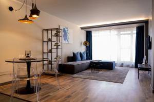 a living room with a couch and a table at City Art Luxury Living Free Parking in Ruse