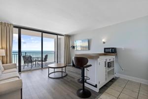 a living room with a couch and a table with a counter at Lively Views from the balcony at Ocean Forest Plaza in Myrtle Beach