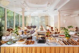 un buffet con pane e altri prodotti alimentari su un tavolo di Hotel Gallia Palace a Rimini