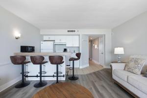 a living room with a couch and a kitchen at Lively Views from the balcony at Ocean Forest Plaza in Myrtle Beach +26 photos