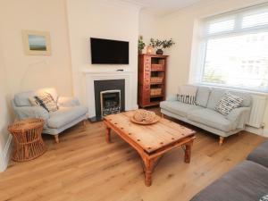 a living room with a coffee table and a fireplace at Number 20 in Morpeth
