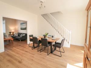 a dining room and living room with a table and chairs at Number 20 in Morpeth