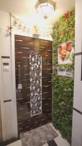 a entrance to a bathroom with a door with a plant at CITY HOMES ORCHID APARTMENT in Mumbai +27 photos