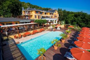 an aerial view of a resort with a pool and umbrellas at Les Trésoms Lake and Spa Resort in Annecy