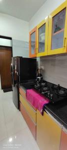 a kitchen with a counter with a pink towel at CITY HOMES PARADISE APARTMENT in Mumbai