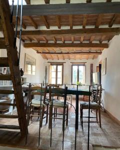 a dining room with a table and chairs at Brunhouse in San Quirico dʼOrcia +65 photos