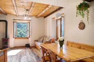 a living room with a wooden table and a couch at Bellavista in Chiesa in Valmalenco