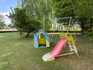 two childrens playground equipment in a park at Agriturismo Cascina Mora in Pavia