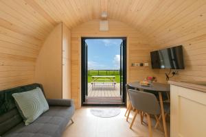 a small living room with a couch and a table at Green Fields in Penzance