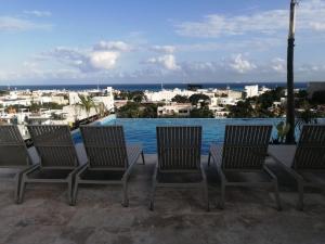 a group of chairs sitting on top of a building at GM Luxury Condo Playa del Carmen in Playa del Carmen