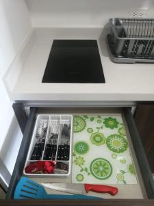 a drawer in a kitchen counter with utensils at GM Luxury Condo Playa del Carmen in Playa del Carmen