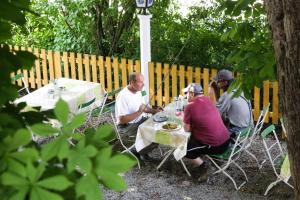 a group of people sitting at a picnic table at Landgasthof Pauliwirt in Erharting