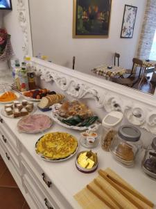a table with many different types of food on it at B&B Villa Pietrachiara in Bari