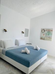 a bed in a white room with two pillows on it at Lefki villa in Polychrono